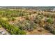 Overhead shot of a property featuring a single Gathering home surrounded by lush trees in a dense forest at 13386 Taylor St, Brooksville, FL 34613