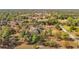 This aerial photo shows a home and shed nestled among the trees, as well as a driveway, and road at 13386 Taylor St, Brooksville, FL 34613