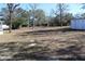 Large backyard with minimal grass, some trees and a storage building at 13386 Taylor St, Brooksville, FL 34613