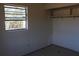 A view of a empty bedroom with plain walls and printed floors at 13386 Taylor St, Brooksville, FL 34613