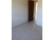 A view of a empty bedroom with plain walls and printed floors at 13386 Taylor St, Brooksville, FL 34613