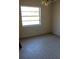 A view of a empty bedroom with plain walls and printed floors at 13386 Taylor St, Brooksville, FL 34613