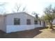 Exterior angle of a cozy one-story home with painted brick facade, multi-paned windows, and a chimney at 13386 Taylor St, Brooksville, FL 34613