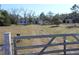 View of the home from the gated entry and long driveway at 13386 Taylor St, Brooksville, FL 34613