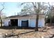 Exterior view of the detached garage with two doors and debris on the lawn at 13386 Taylor St, Brooksville, FL 34613