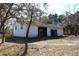 Exterior view of the detached garage with two doors, one open, and lawn debris at 13386 Taylor St, Brooksville, FL 34613