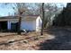 Exterior view of detached garage with two doors and lawn debris at 13386 Taylor St, Brooksville, FL 34613