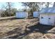 Image of three white outbuildings or sheds located on the property at 13386 Taylor St, Brooksville, FL 34613