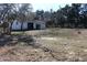 Backyard view of the lot with cut limbs laying on the ground at 13386 Taylor St, Brooksville, FL 34613