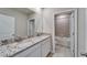 Bathroom with double sink vanity and a tiled shower/bath at 16725 Barnwood Pl, Bradenton, FL 34211