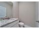 Powder room with a granite countertop vanity and a toilet at 16725 Barnwood Pl, Bradenton, FL 34211