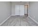 Neutral carpeted bedroom with closet and a view of another room at 16725 Barnwood Pl, Bradenton, FL 34211