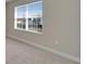 Bedroom with neutral walls and carpet featuring a bright window at 16725 Barnwood Pl, Bradenton, FL 34211