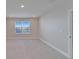 Bedroom featuring plush carpet, base trim, recessed lighting, and a bright window at 16725 Barnwood Pl, Bradenton, FL 34211