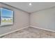 Cozy bedroom featuring plush carpet and a sunny window overlooking a pond view at 16725 Barnwood Pl, Bradenton, FL 34211