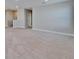 Spacious carpeted bonus room with neutral walls leading to the staircase and a hallway with linen closet at 16725 Barnwood Pl, Bradenton, FL 34211