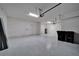 Empty garage with white walls, speckled epoxy flooring, and garage door openers at 16725 Barnwood Pl, Bradenton, FL 34211