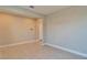 Empty living room with tile flooring, neutral walls, and view into hallway and doorway at 16725 Barnwood Pl, Bradenton, FL 34211