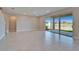 Open floor plan living room with tile flooring and a large glass sliding door at 16725 Barnwood Pl, Bradenton, FL 34211