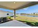 Covered patio with beautiful view of a pond and fountain at 16725 Barnwood Pl, Bradenton, FL 34211