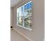 Close up of window with view of green space and trees, with mini-blinds at 16725 Barnwood Pl, Bradenton, FL 34211