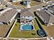 Aerial view of a backyard with a swimming pool, patio, and a trampoline at 16733 Glacier Bay Loop, Wimauma, FL 33598