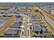 An aerial view of a residential street featuring modern homes with manicured lawns and attached garages at 16733 Glacier Bay Loop, Wimauma, FL 33598