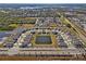 Aerial view of a neighborhood featuring modern homes surrounding a central pond at 16733 Glacier Bay Loop, Wimauma, FL 33598