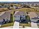 Aerial view of a modern two-story home with a well-kept lawn in a suburban neighborhood at 16733 Glacier Bay Loop, Wimauma, FL 33598