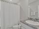 This bathroom has granite counters, a white cabinet, and a shower-tub combo at 16733 Glacier Bay Loop, Wimauma, FL 33598