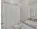 This bathroom has granite counters, a white cabinet, and a shower-tub combo at 16733 Glacier Bay Loop, Wimauma, FL 33598