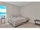 This bedroom has two twin beds with neutral bedding and a bedside table at 16733 Glacier Bay Loop, Wimauma, FL 33598