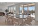 Dining room with modern glass table, seating for eight, and sliding door to the pool at 16733 Glacier Bay Loop, Wimauma, FL 33598