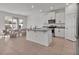 Open-concept kitchen and dining area with white cabinetry, granite countertops, and stainless steel appliances at 16733 Glacier Bay Loop, Wimauma, FL 33598