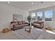 Bright living room with neutral furniture, contemporary rug, and lots of natural light at 16733 Glacier Bay Loop, Wimauma, FL 33598