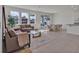 Bright living room with neutral furniture, contemporary rug, and open floor plan at 16733 Glacier Bay Loop, Wimauma, FL 33598