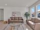 Bright living room with neutral furniture, contemporary rug, and lots of natural light at 16733 Glacier Bay Loop, Wimauma, FL 33598