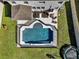 Aerial view of private pool and patio area with lounge chairs and a trampoline at 16733 Glacier Bay Loop, Wimauma, FL 33598