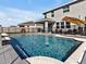 Swimming pool with clear, blue water surrounded by a fenced-in yard at 16733 Glacier Bay Loop, Wimauma, FL 33598