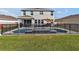 Backyard view of pool with fencing and grass area, providing a relaxing outdoor space at 16733 Glacier Bay Loop, Wimauma, FL 33598