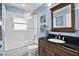 Updated bathroom with a tub shower combo and dark wood vanity at 17112 Downs Dr, Odessa, FL 33556