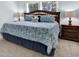 King-size bedroom with dark wood furniture and patterned bedding at 17112 Downs Dr, Odessa, FL 33556