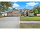 Beautiful two-story home with a three-car garage and well-manicured lawn at 17112 Downs Dr, Odessa, FL 33556