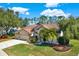 Two-story home with a three-car garage and beautiful landscaping at 17112 Downs Dr, Odessa, FL 33556