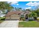 Spacious house with three-car garage and palm trees at 17112 Downs Dr, Odessa, FL 33556