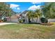 Beautiful two-story home with a three-car garage and lush landscaping at 17112 Downs Dr, Odessa, FL 33556