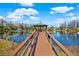 Lakeside gazebo with wooden walkway at 17112 Downs Dr, Odessa, FL 33556