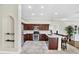 Open kitchen with island seating and view into the Gathering room at 17112 Downs Dr, Odessa, FL 33556