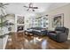 Bright living room featuring hardwood floors and a cozy fireplace at 17112 Downs Dr, Odessa, FL 33556