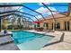 Spacious screened pool area with patio furniture and beautiful landscaping at 17112 Downs Dr, Odessa, FL 33556